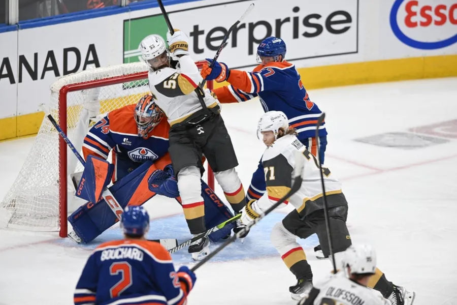 May 10, 2025; Edmonton, Alberta, CAN; Edmonton Oilers goalie Stuart Skinner (74) looks for the puck while Vegas Golden Knights right winger Keegan Kolesar (55) and Oilers defenceman Brett Kulak (27) battle during the third period in game three of the second round of the 2025 Stanley Cup Playoffs at Rogers Place. Mandatory Credit: Walter Tychnowicz-Imagn Images