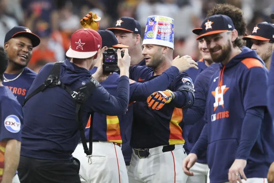 May 25, 2025; Houston, Texas, USA; Houston Astros first baseman Christian Walker (8) wears a bubble gum container on his head after hitting a walk-off home run during the ninth inning against the Seattle Mariners at Daikin Park. Mandatory Credit: Troy Taormina-Imagn Images
