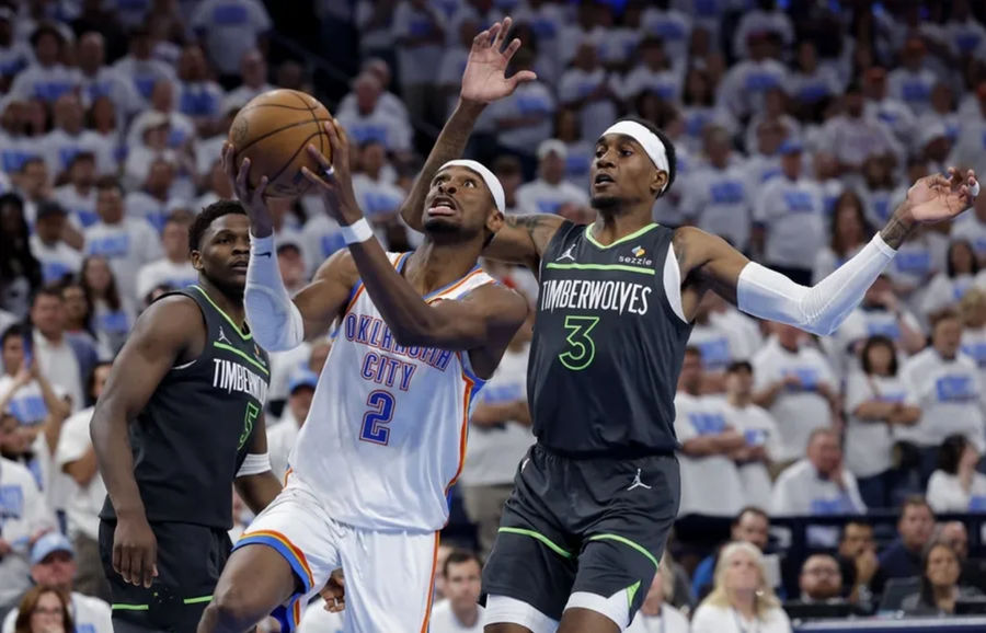 May 20, 2025; Oklahoma City, Oklahoma, USA; Oklahoma City Thunder guard Shai Gilgeous-Alexander (2) drives against Minnesota Timberwolves forward Jaden McDaniels (3) in the fourth quarter during game one of the western conference finals for the 2025 NBA Playoffs at Paycom Center. Mandatory Credit: Alonzo Adams-Imagn Images