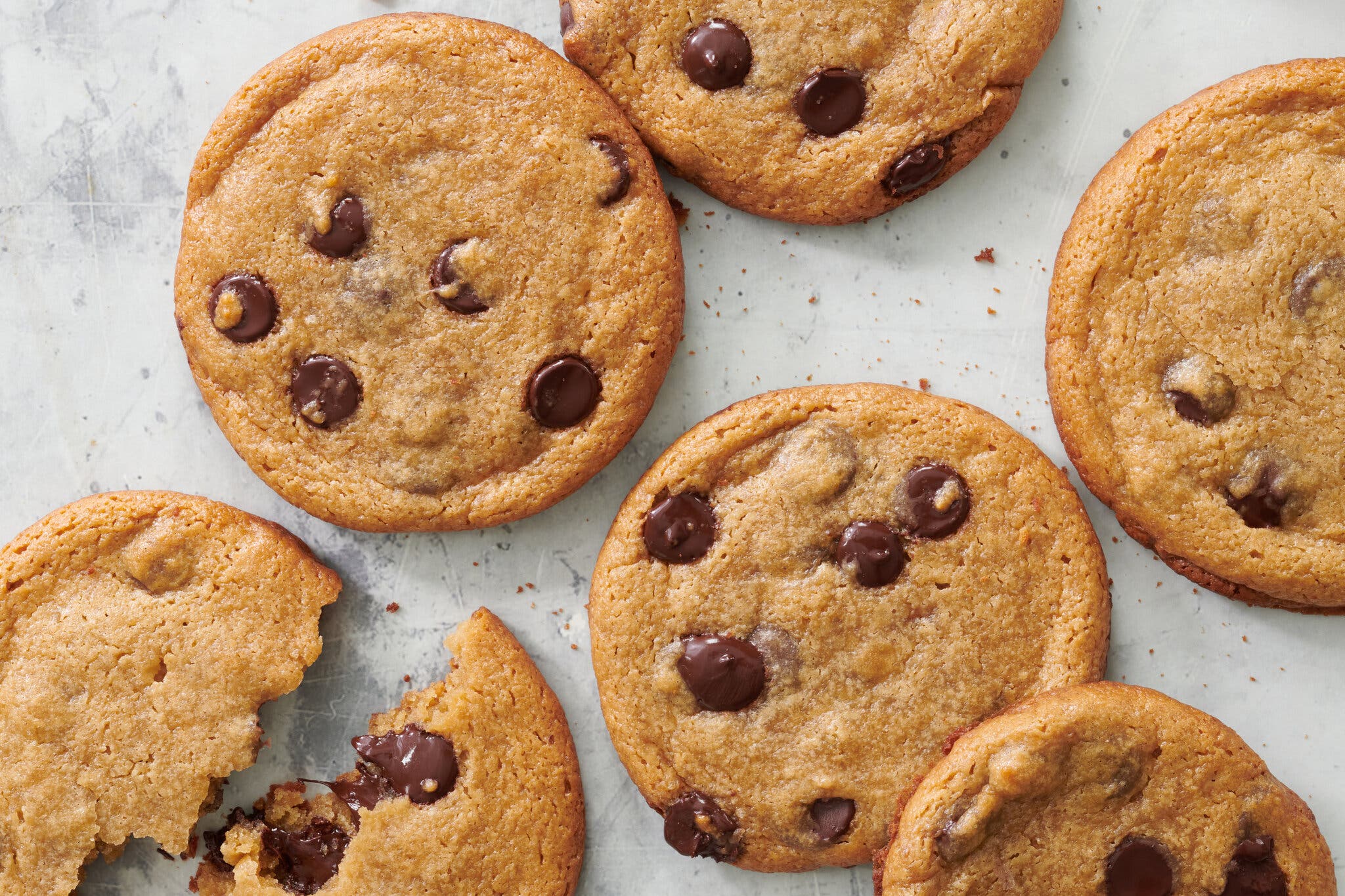 A half-dozen miso chocolate chip cookies sit on a baking pan.