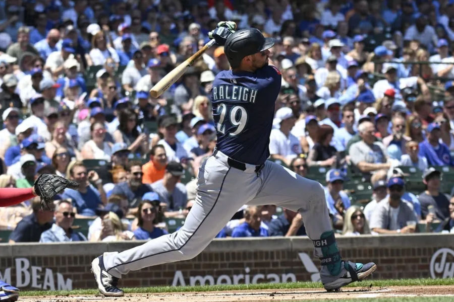 Jun 20, 2025; Chicago, Illinois, USA; Seattle Mariners catcher Cal Raleigh (29) hits a home run against the Chicago Cubs during the first inning at Wrigley Field. Mandatory Credit: Matt Marton-Imagn Images
