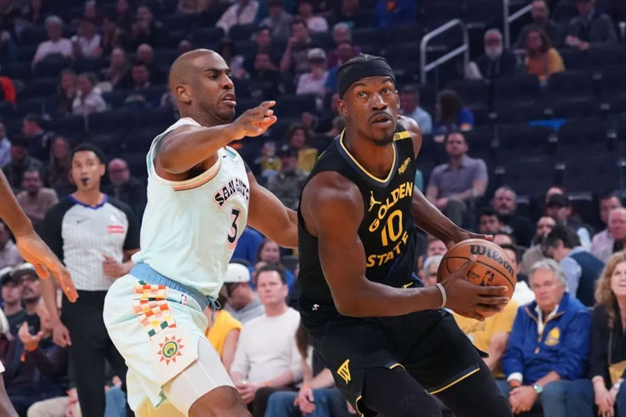 Apr 9, 2025; San Francisco, California, USA; Golden State Warriors forward Jimmy Butler III (10) dribbles by San Antonio Spurs guard Chris Paul (3) in the first period at Chase Center. Mandatory Credit: David Gonzales-Imagn Images