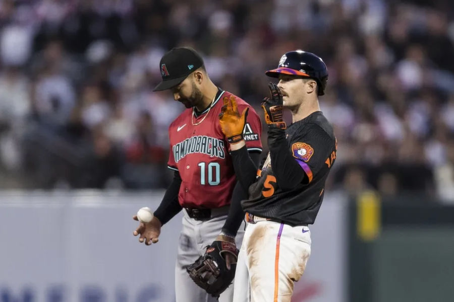 May 13, 2025; San Francisco, California, USA; Arizona Diamondbacks shortstop Jordan Lawlar (10) tosses the ball as San Francisco Giants right fielder Mike Yastrzemski (5) reacts after hitting a double during the fourth inning at Oracle Park. Mandatory Credit: John Hefti-Imagn Images