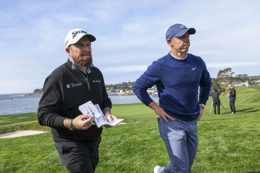 Feb 2, 2025; Pebble Beach, California, USA; Shane Lowry (left) and Rory McIlroy (right) on the fifth hole during the final round of the AT&T Pebble Beach Pro-Am golf tournament at Pebble Beach Golf Links. Mandatory Credit: Kiyoshi Mio-Imagn Images