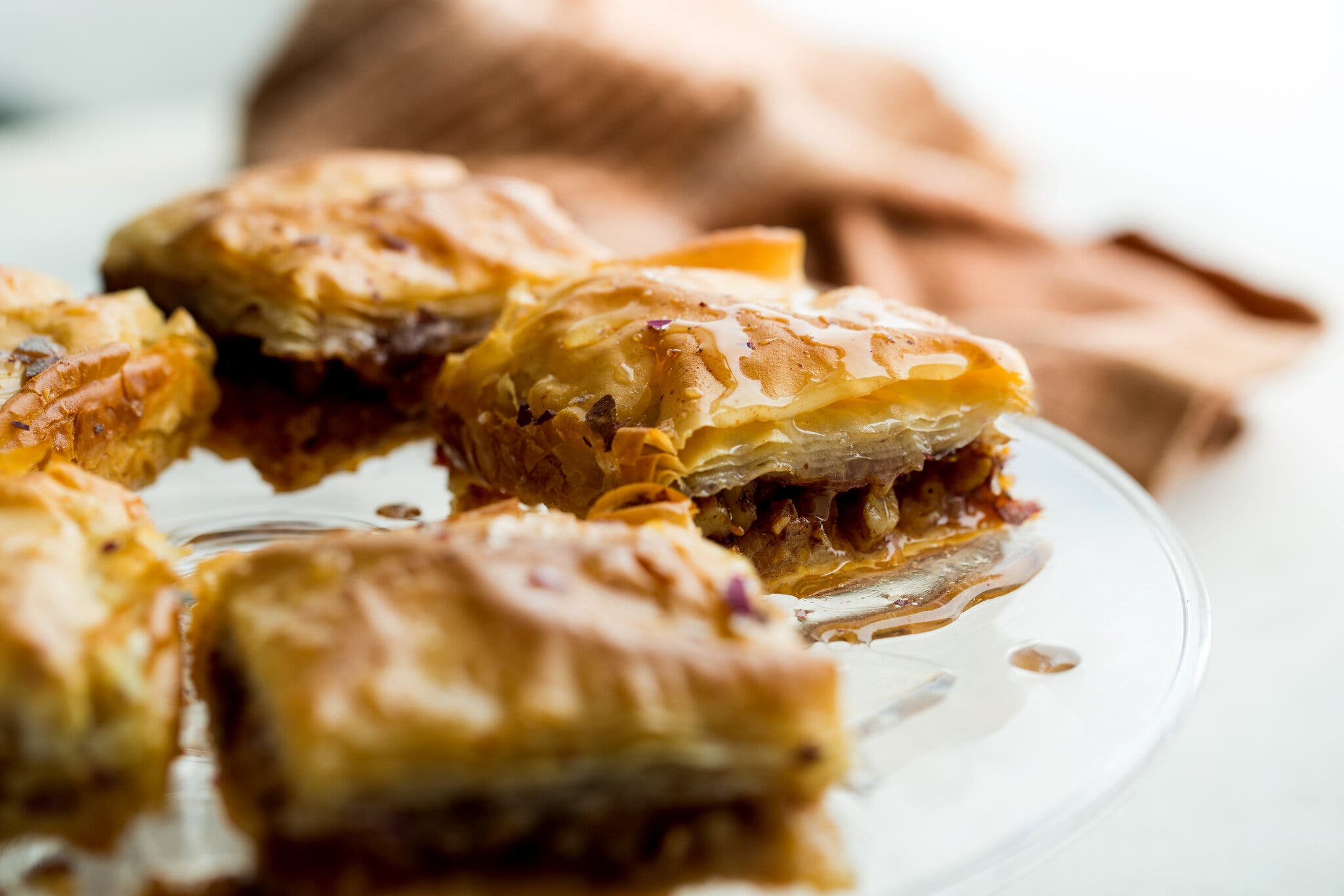 A side image of several squares of baklava, the nutty insides exposed.