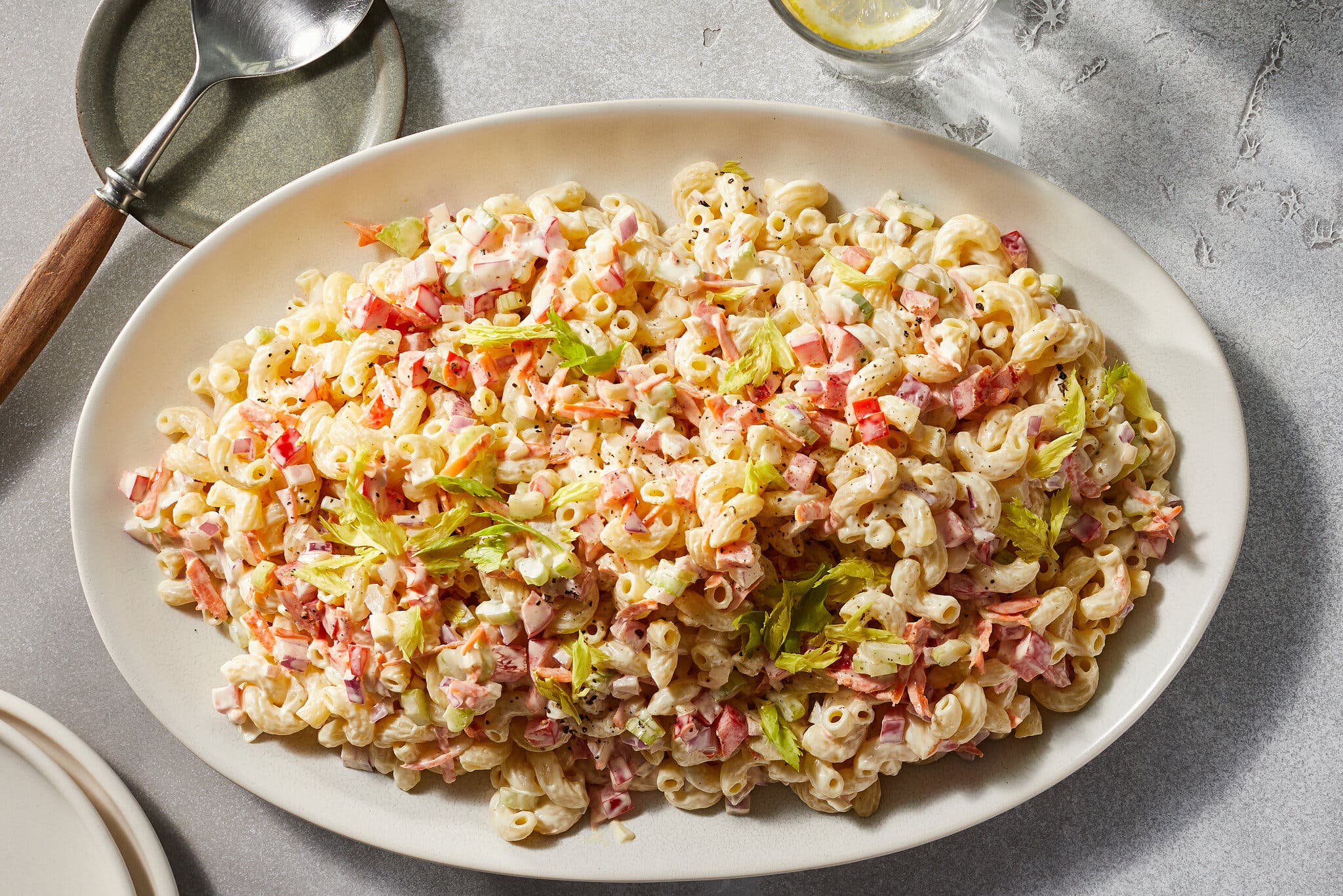 An overhead image of macaroni elbows tossed with celery and bell pepper.