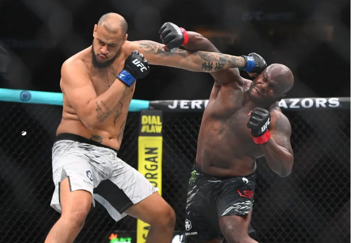 Jul 12, 2025; Nashville, Tennessee, United States; Derrick Lewis (red gloves) fights Tallison Teixeira (blue gloves) in a heavyweight bout during UFC Fight Night at Bridgestone Arena. Mandatory Credit: Steve Roberts-Imagn Images