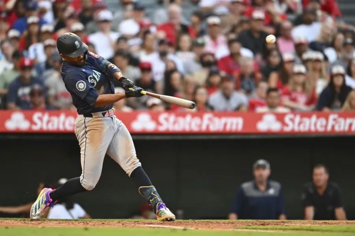 Jul 26, 2025; Anaheim, California, USA; Seattle Mariners outfielder Julio Rodríguez (44) hits a one run home run against the Los Angeles Angels during the third inning at Angel Stadium. Mandatory Credit: Jonathan Hui-Imagn Images