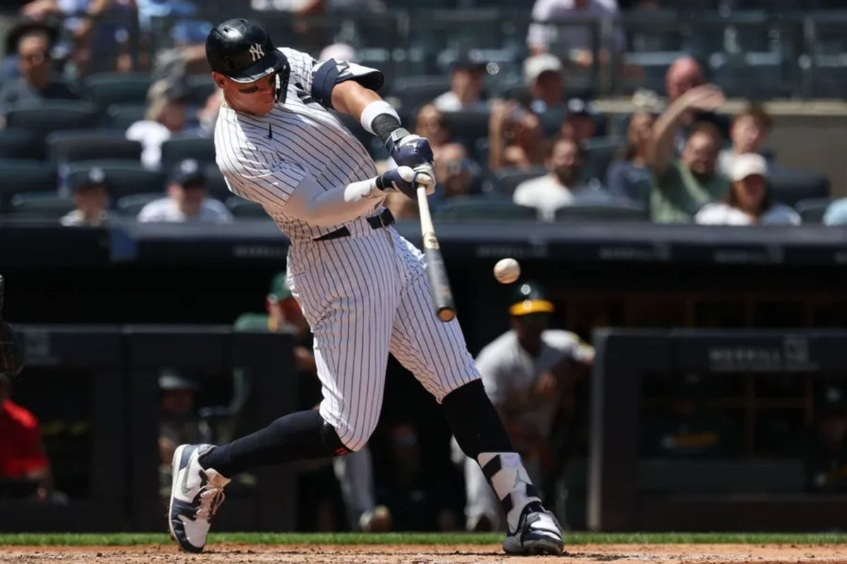 Jun 29, 2025; Bronx, New York, USA; New York Yankees designated hitter Aaron Judge (99) hits a two-run homer during the fourth inning against the Athletics at Yankee Stadium. Mandatory Credit: Vincent Carchietta-Imagn Images