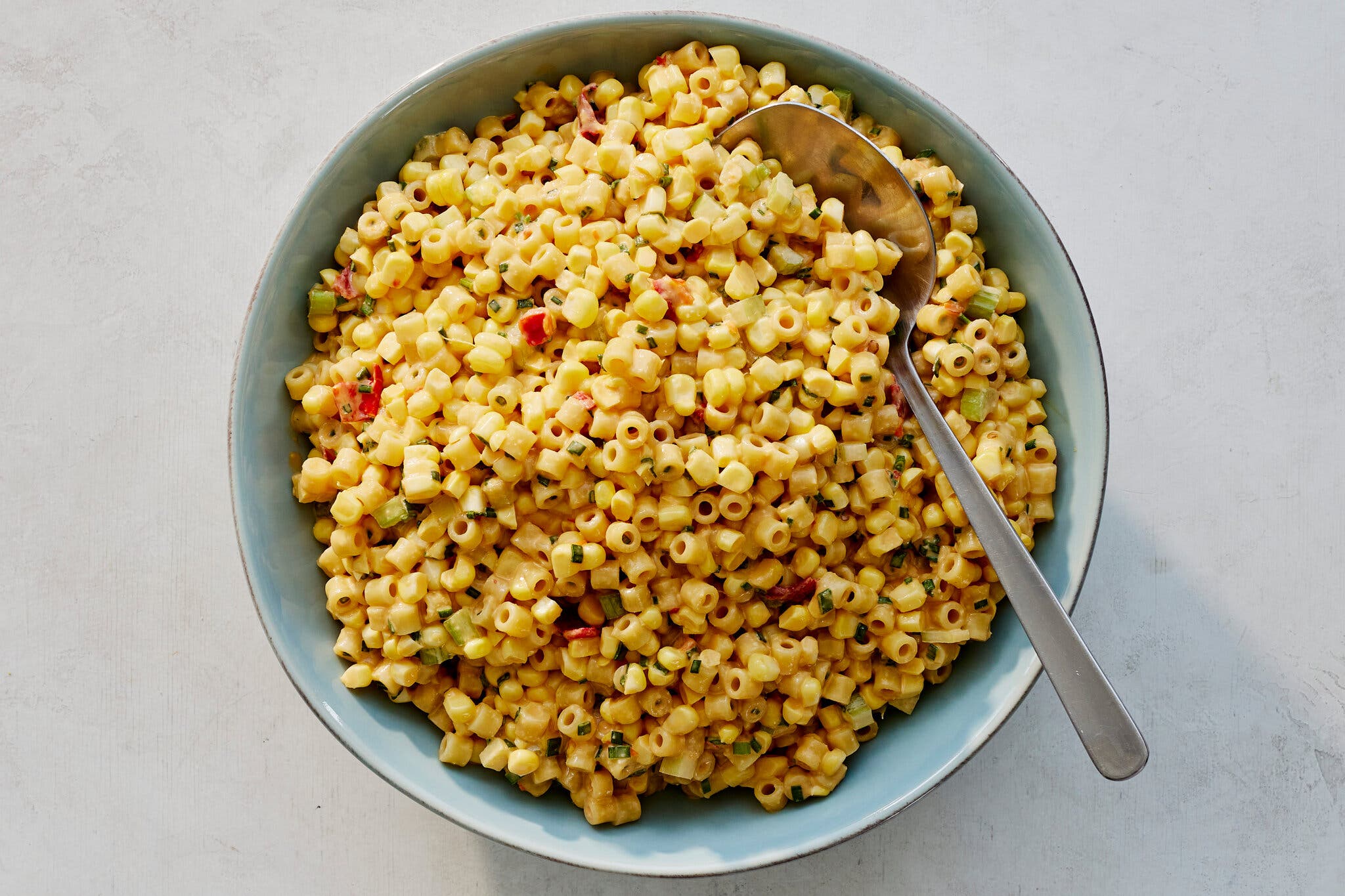 An overhead image of small creamy pasta in a blue bowl.