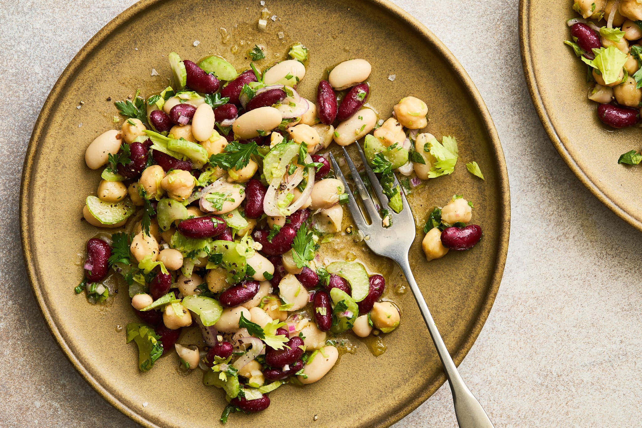 An overhead image of a bean salad on a plate.