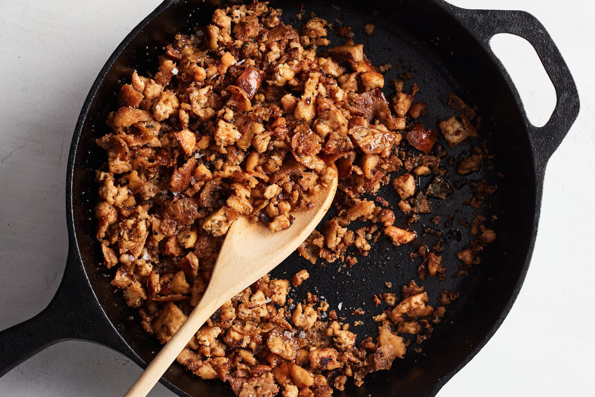 A tofu scramble in a cast-iron skillet is photographed from overhead.