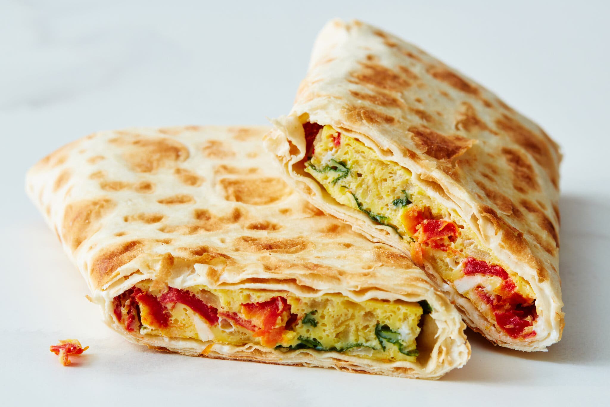 An egg-filled wrap is photographed from the side.