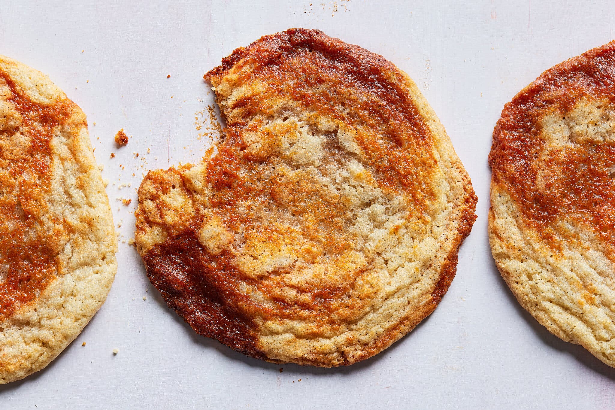 Three gochujang caramel cookies, the middle one with a bit taken out of it.