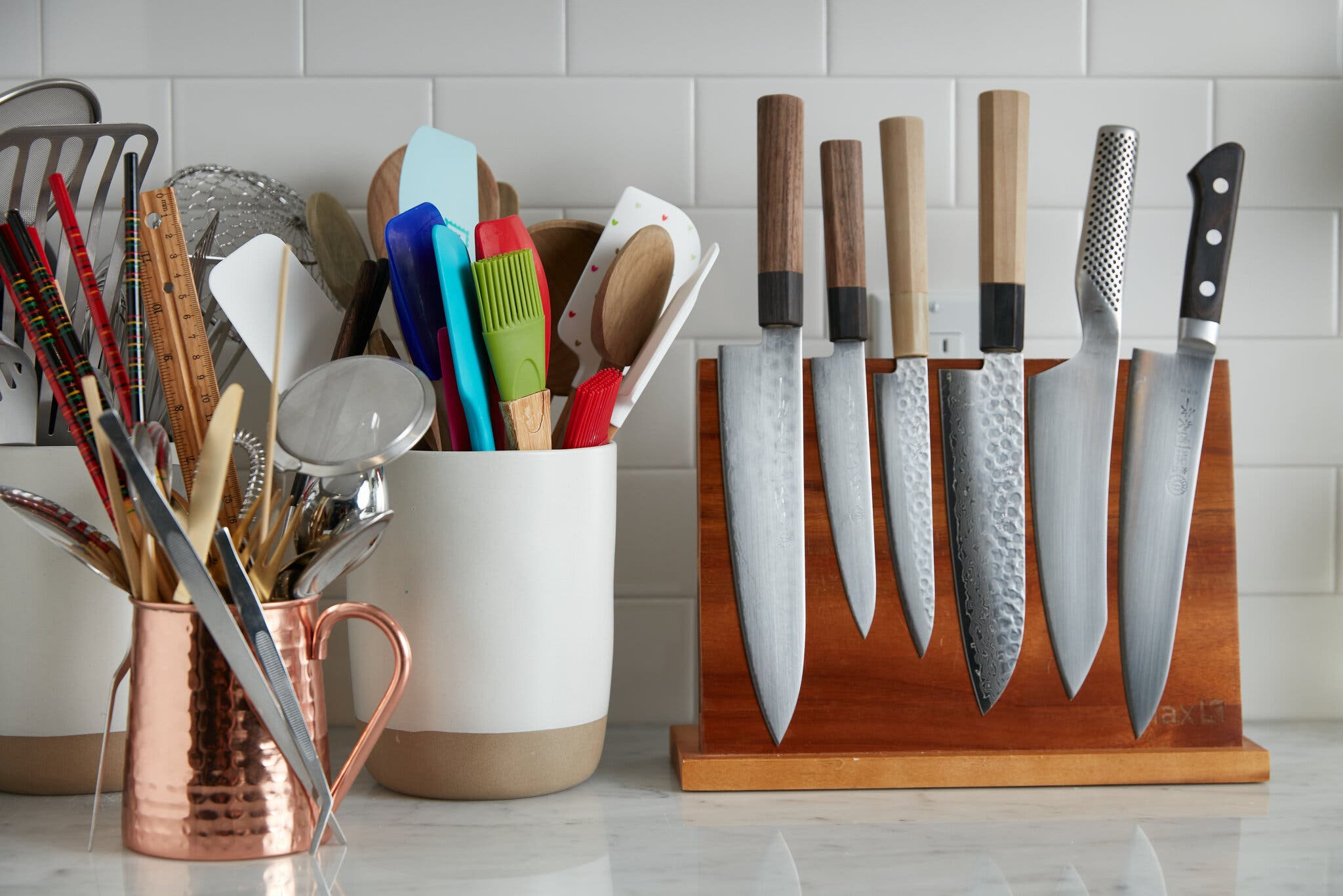 An image of a counter finished with all kinds of cooking utensils.