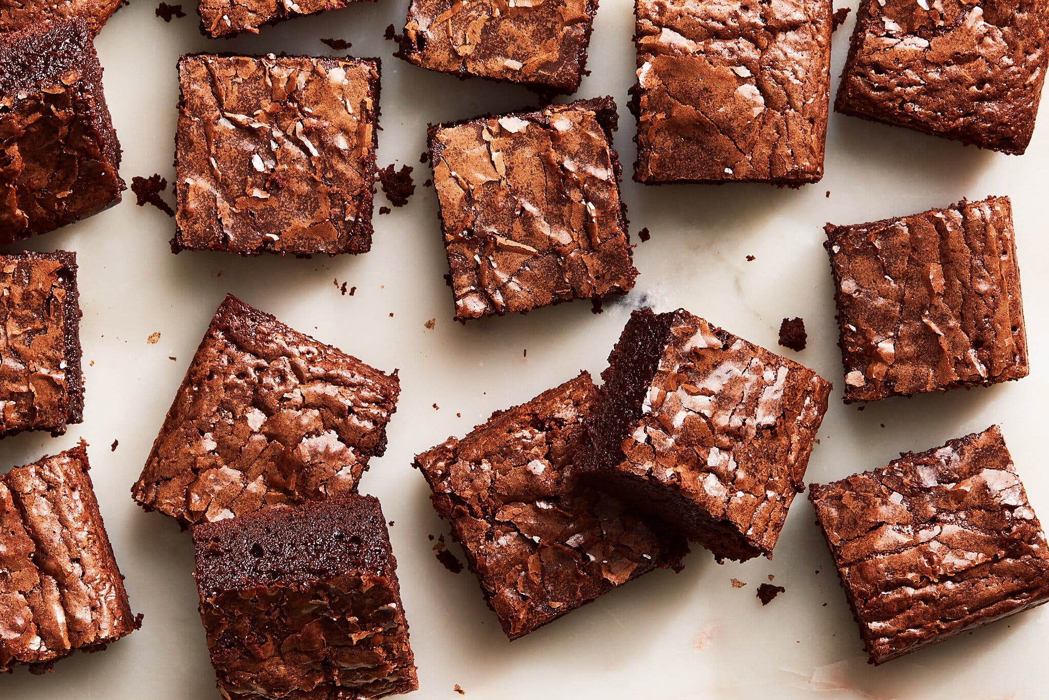 An overhead image of 16 brownies with coffee and cardamom squares.