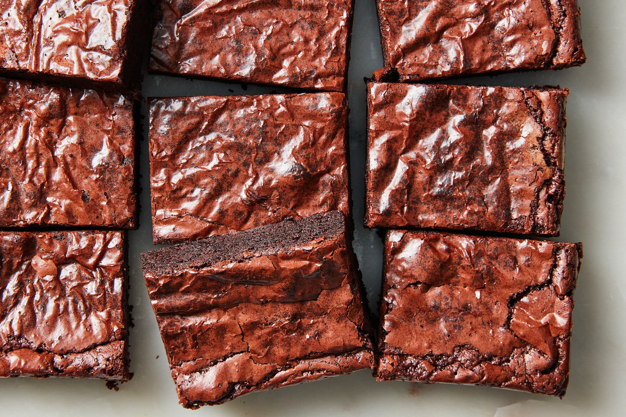 An overhead image of nine brownie squares. with crackly, shiny tops.