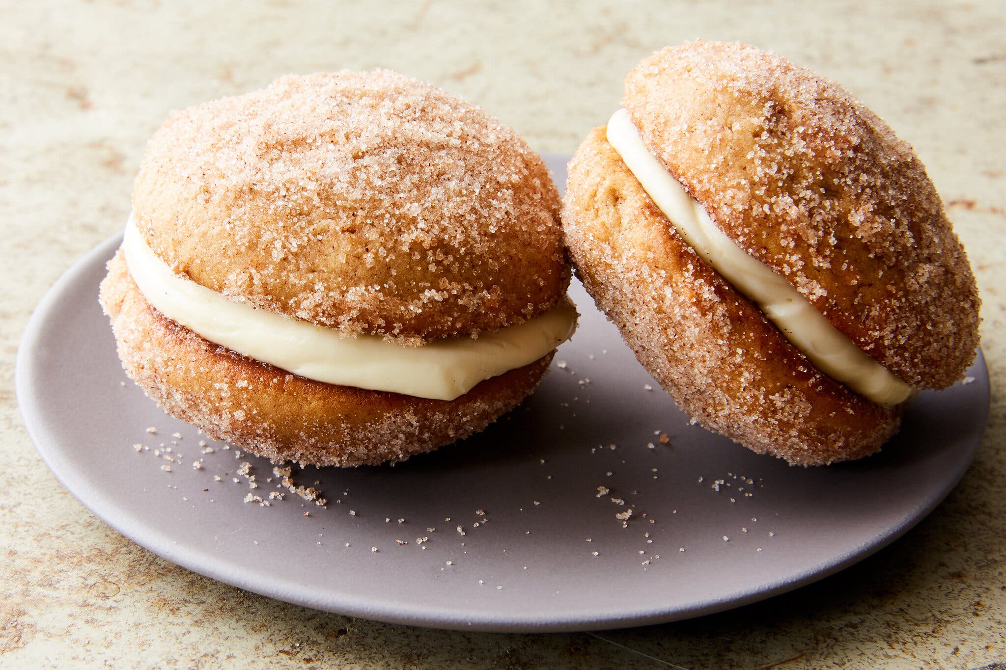 A side image of two whoopie pies finished with cinnamon sugar.