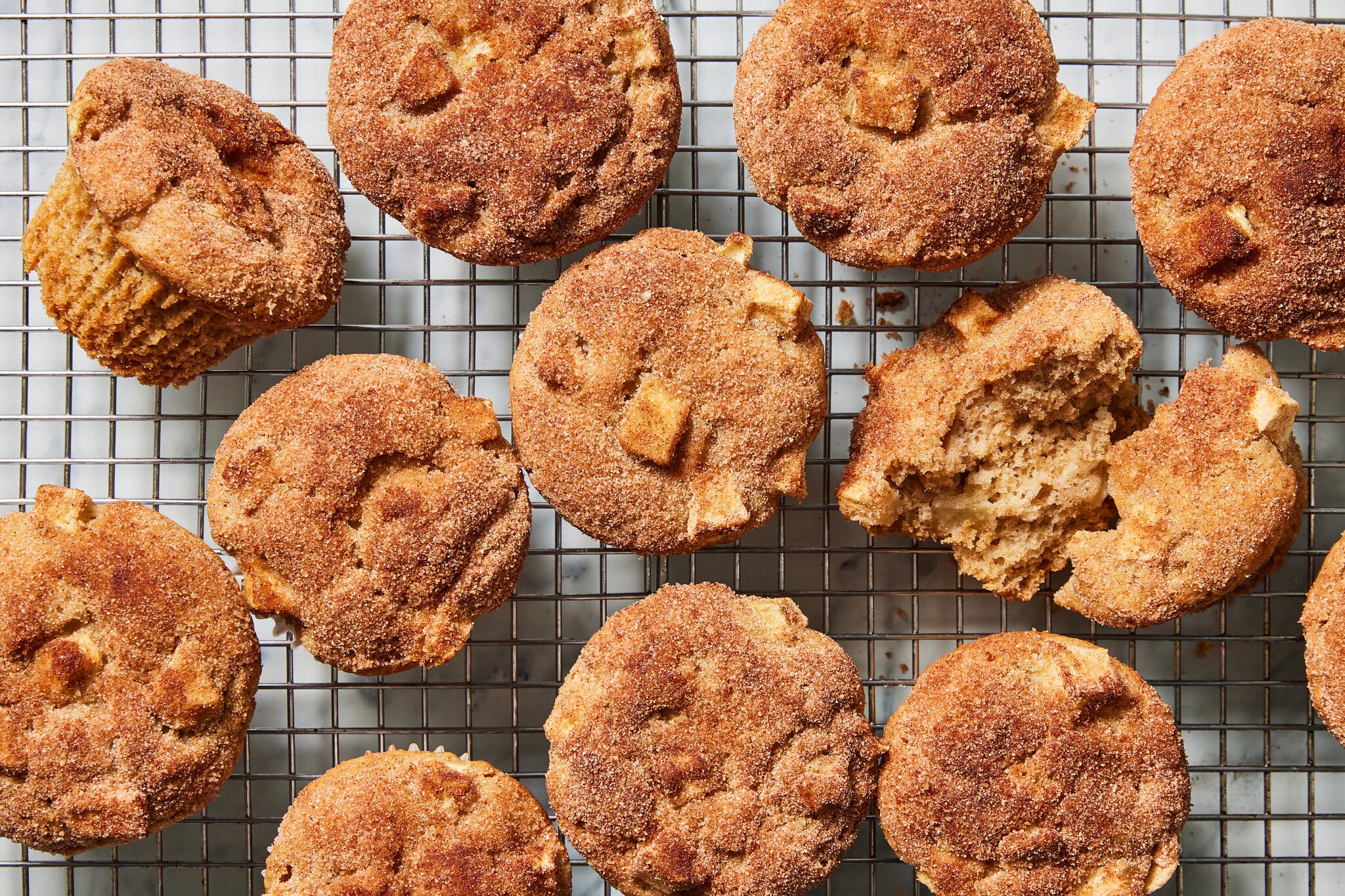 An overhead image of apple cinnamon muffins on a cooling rack.