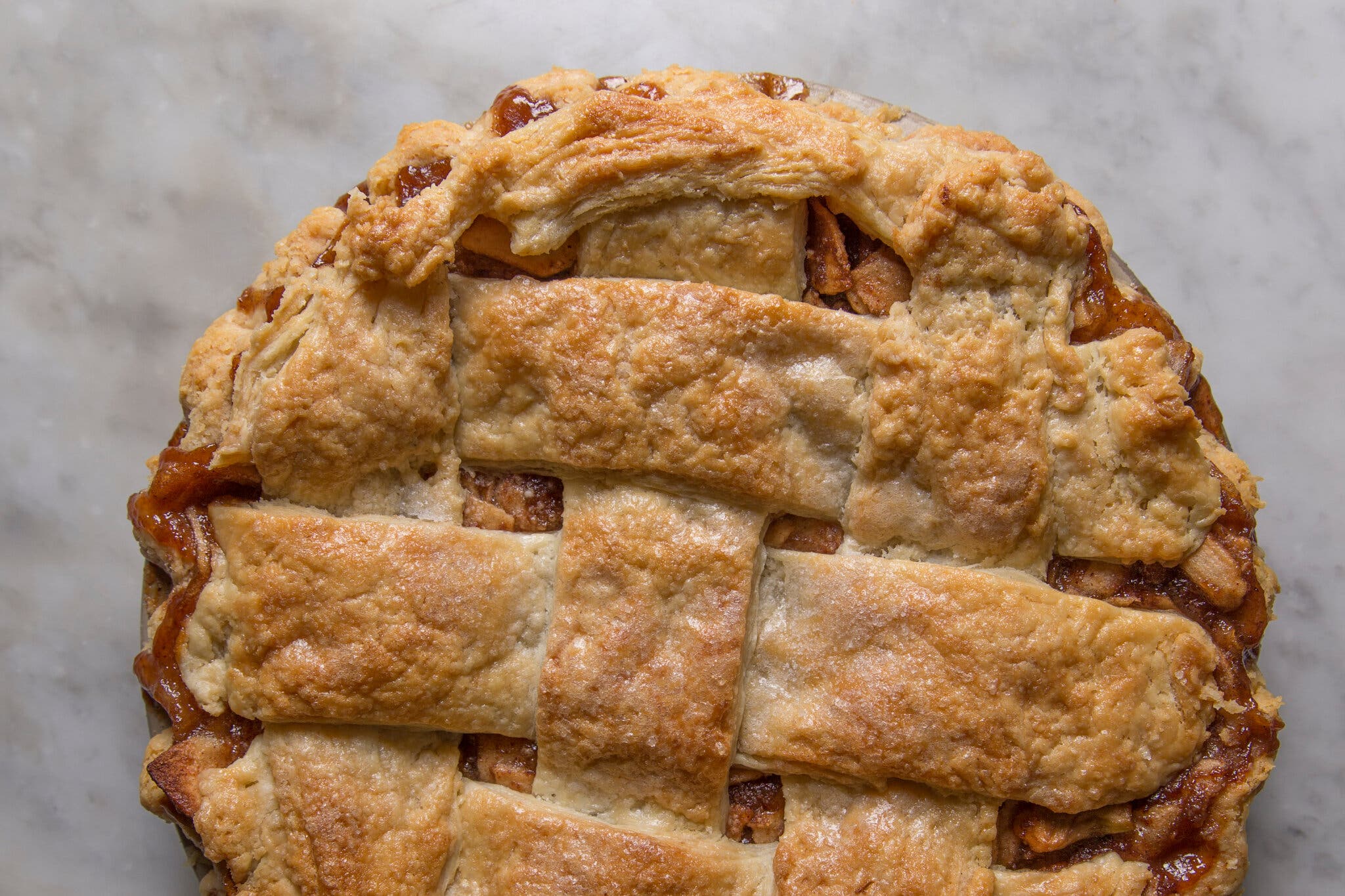 An overhead image of an apple pie with a lattice crust.