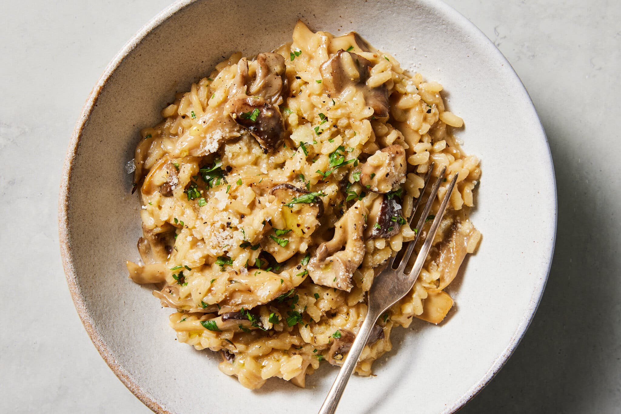 An overhead image of a bowl of mushroom risotto.