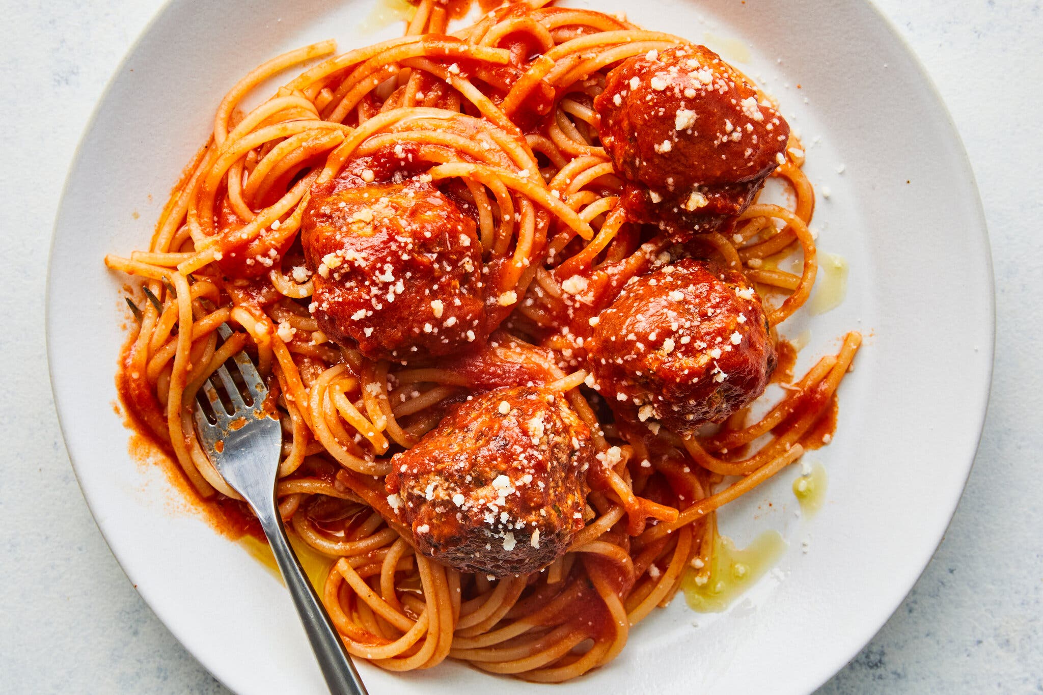An overhead image of a plate of spaghetti and meatballs.