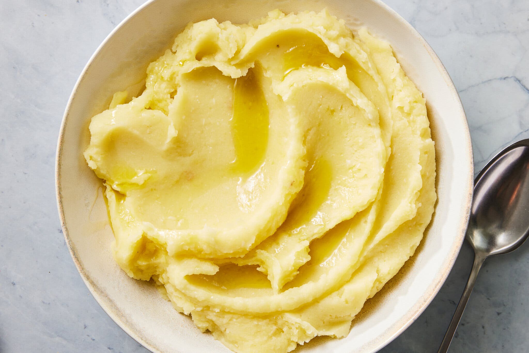 An overhead image of a bowl of olive oil mashed potatoes.