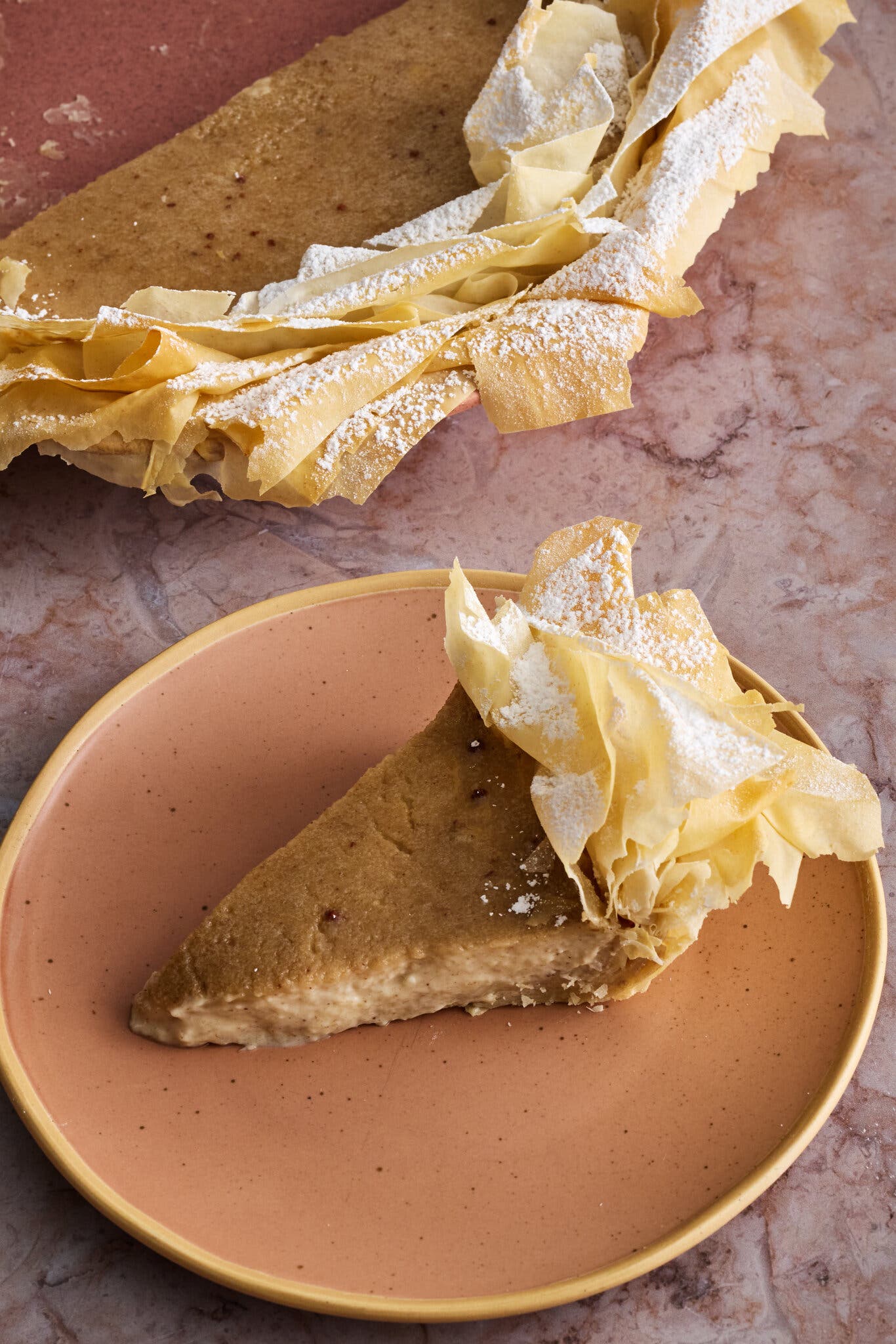 An overhead image of a banana pie with a phyllo crust.