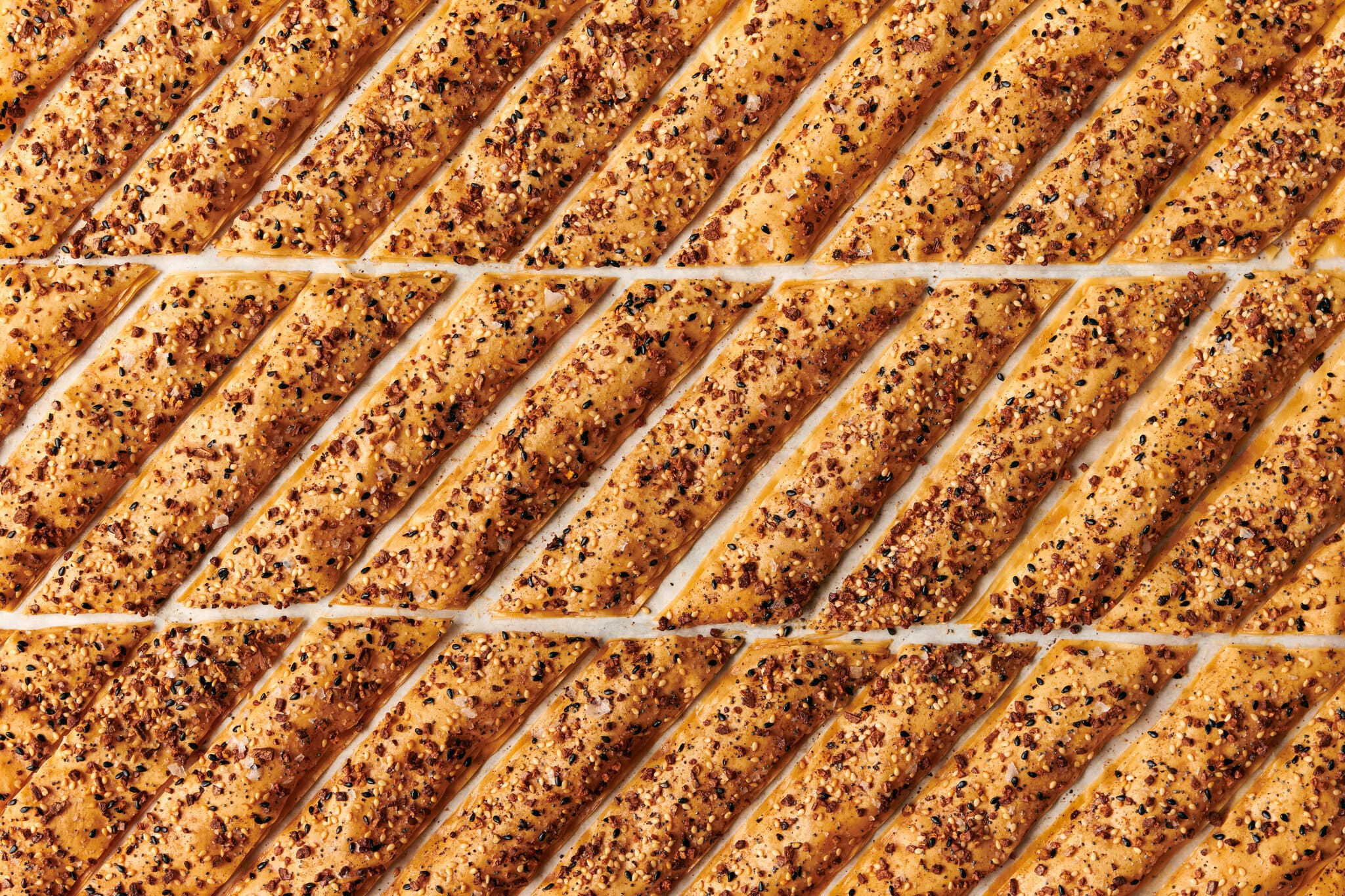 A tight grid of phyllo crackers covered in everything seasoning