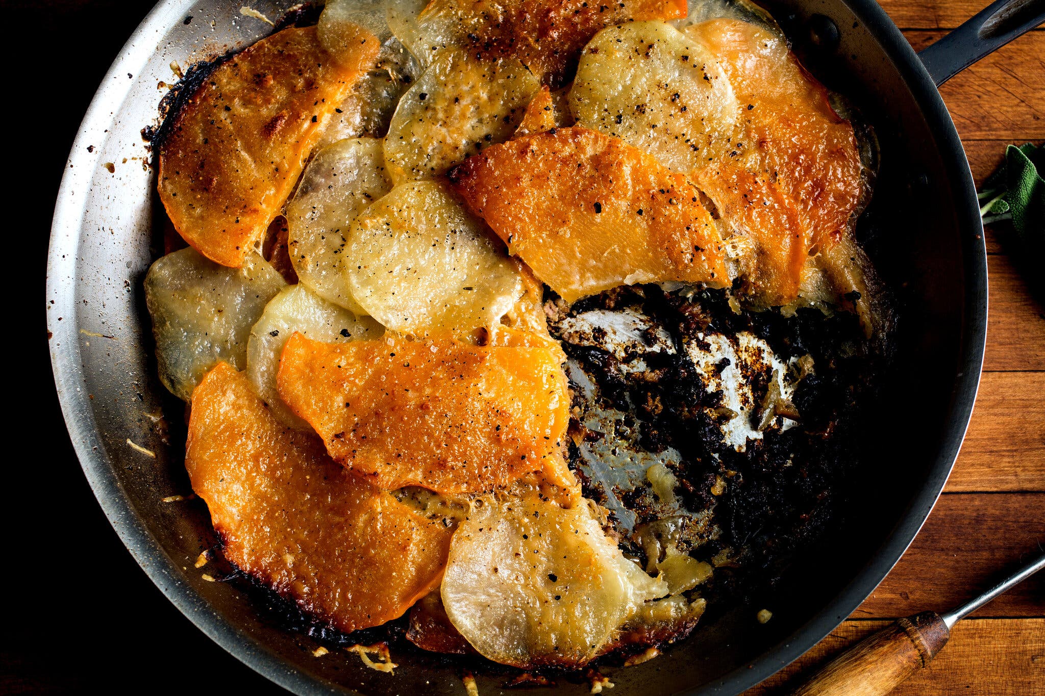 A skilled filled with ground beef and topped with thinly sliced potatoes.