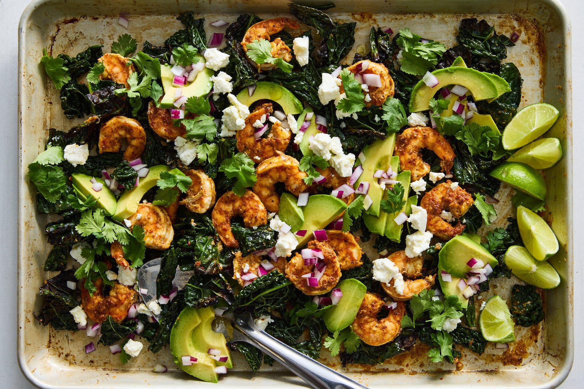 Roasted shrimp and dark leafy kale topped with avocado slices, red onion and crumbled feta.